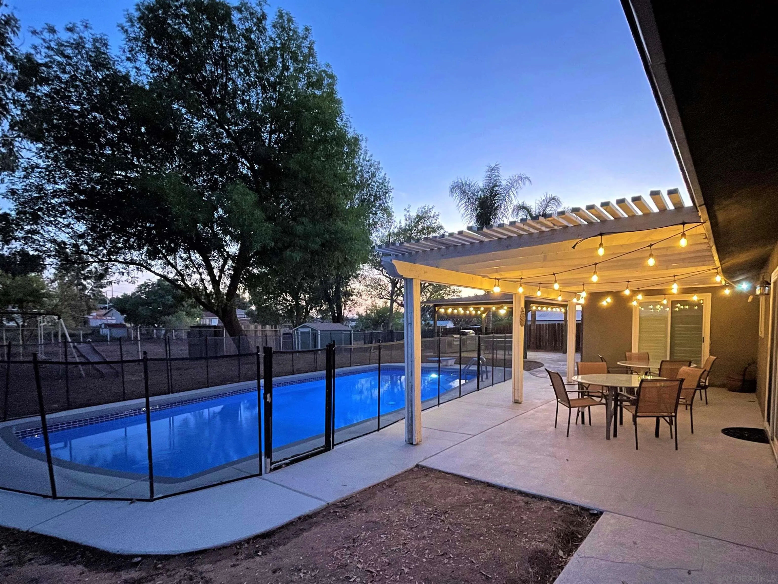 a view of a patio with dining table and chairs