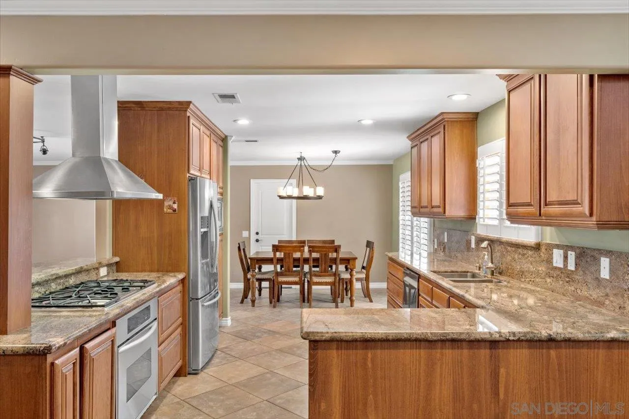 830 Steffy Road Ramona, CA 92065 - Photo 17 of 45 a kitchen with granite countertop a sink and a stove top oven