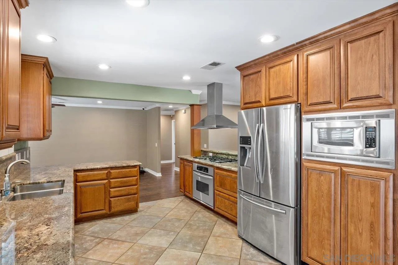 830 Steffy Road Ramona, CA 92065 - Photo 18 of 45 a kitchen with stainless steel appliances granite countertop a refrigerator and a sink