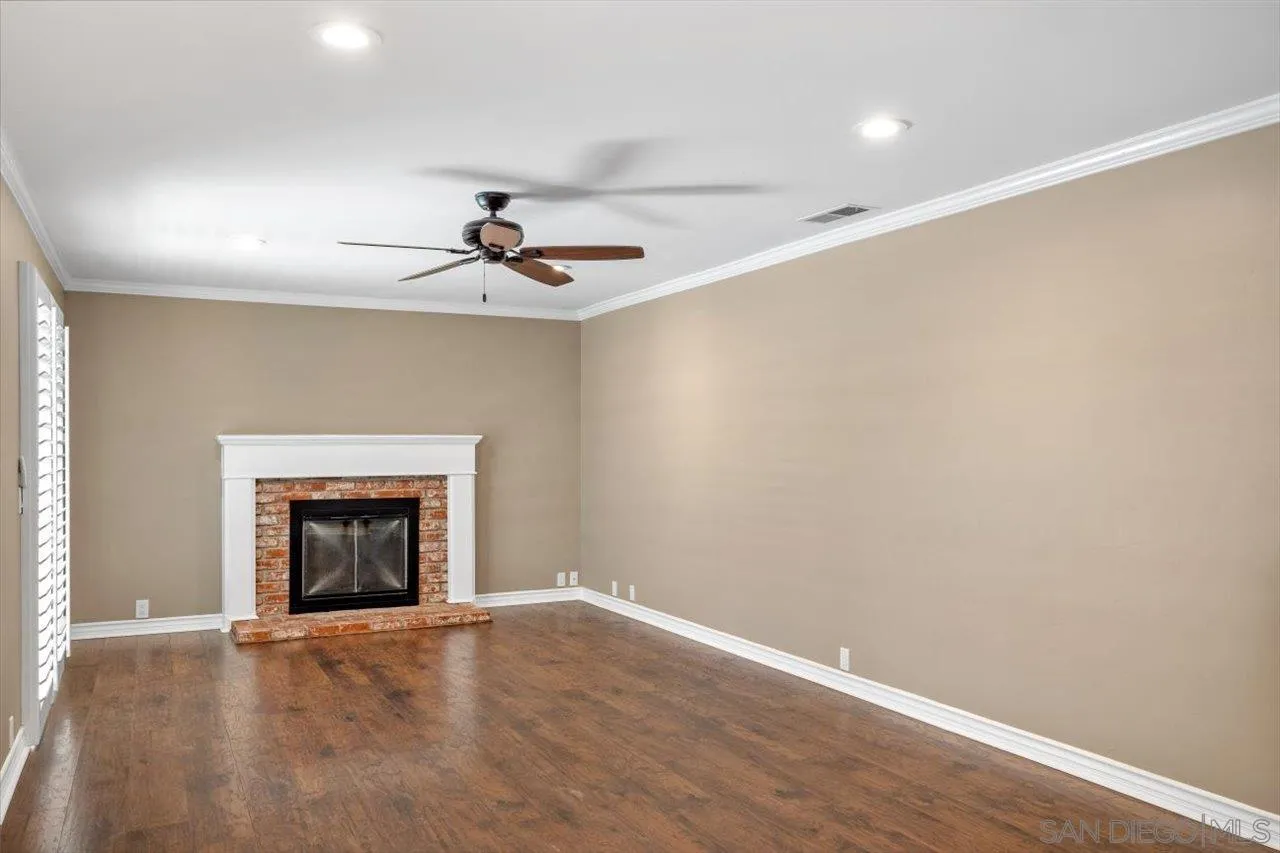 830 Steffy Road Ramona, CA 92065 - Photo 21 of 45 an empty room with a fireplace and fan