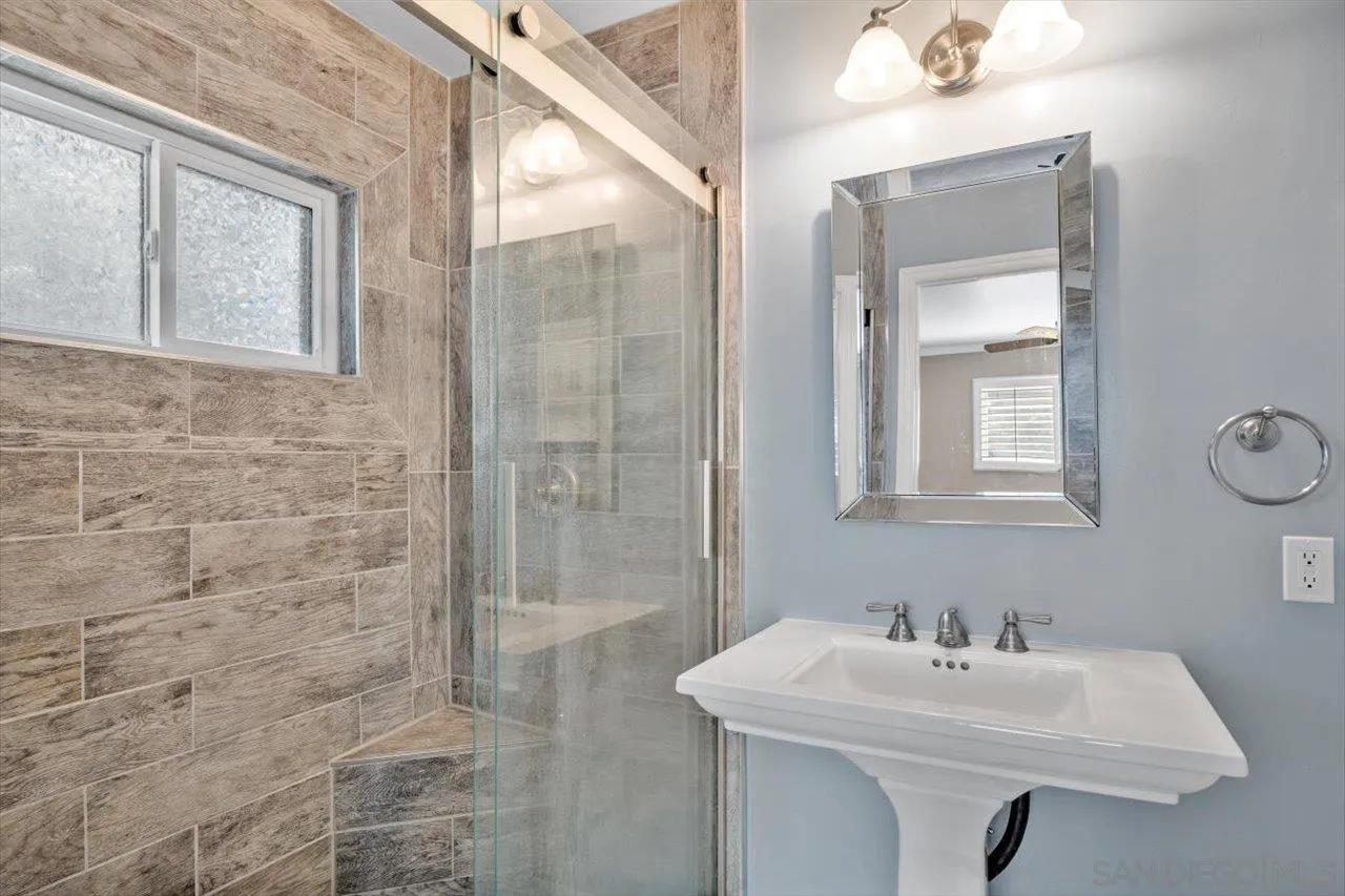 830 Steffy Road Ramona, CA 92065 - Photo 26 of 45 a bathroom with a sink a mirror and a shower