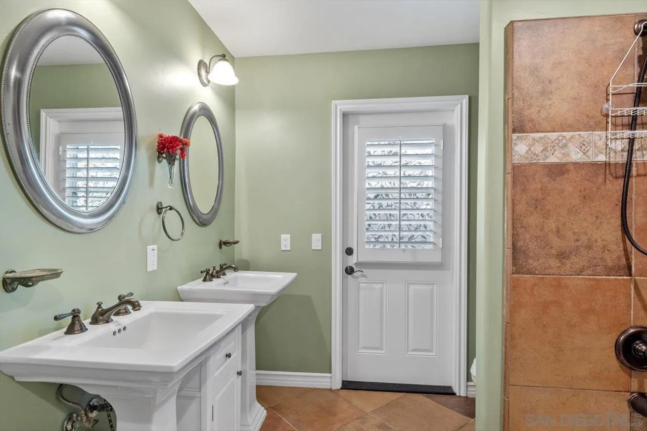 830 Steffy Road Ramona, CA 92065 - Photo 30 of 45 a bathroom with a sink and a mirror