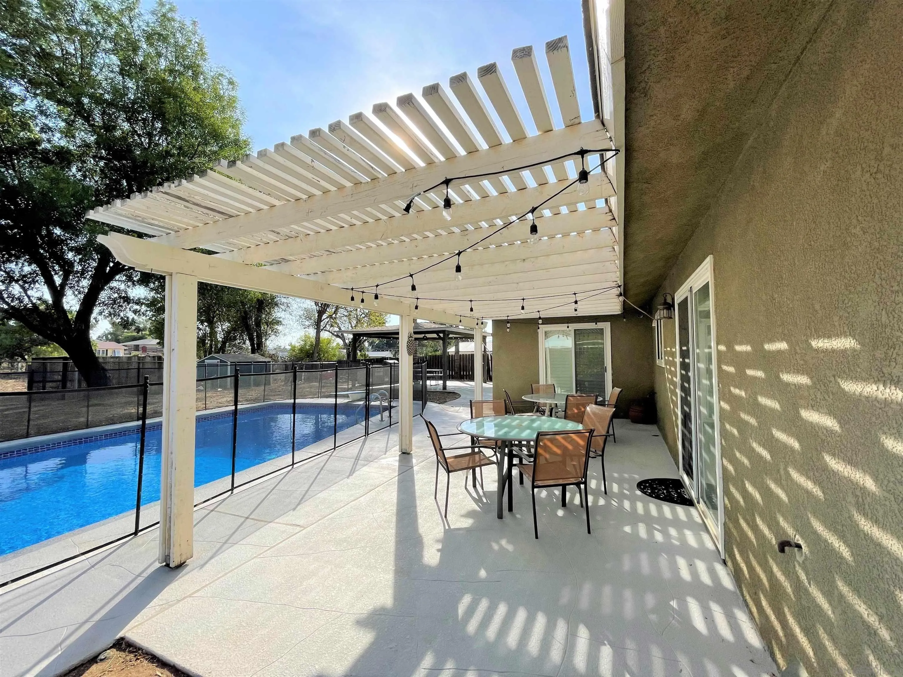 830 Steffy Road Ramona, CA 92065 - Photo 7 of 45 a view of a patio with table and chairs potted plants with wooden floor and fence