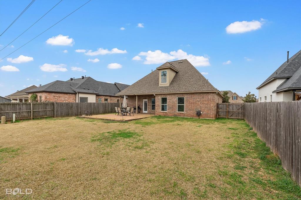 946 Maize Street Bossier City, LA 71111 - Photo 7 of 39 a large house with a big yard and large trees