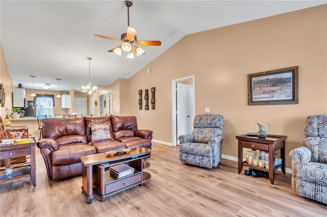 18 Sweetgrass Trail Anderson, SC 29625 - Photo 5 of 26 This inviting living space features vaulted ceilings and wood flooring, flowing seamlessly into the kitchen.