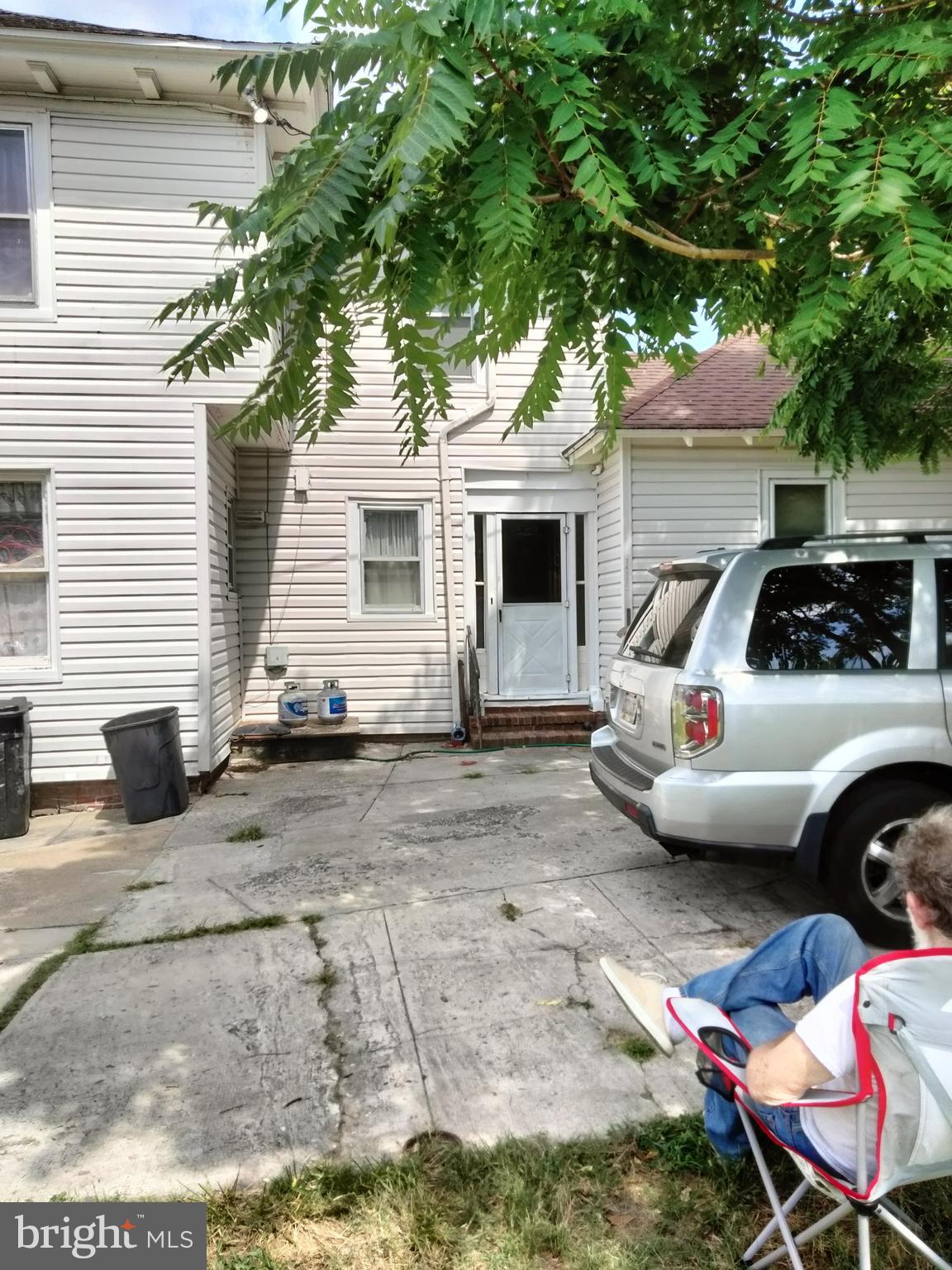 7411 Main Street Willards, MD 21874 - Photo 3 of 43 a view of a backyard with table and chairs and potted plants