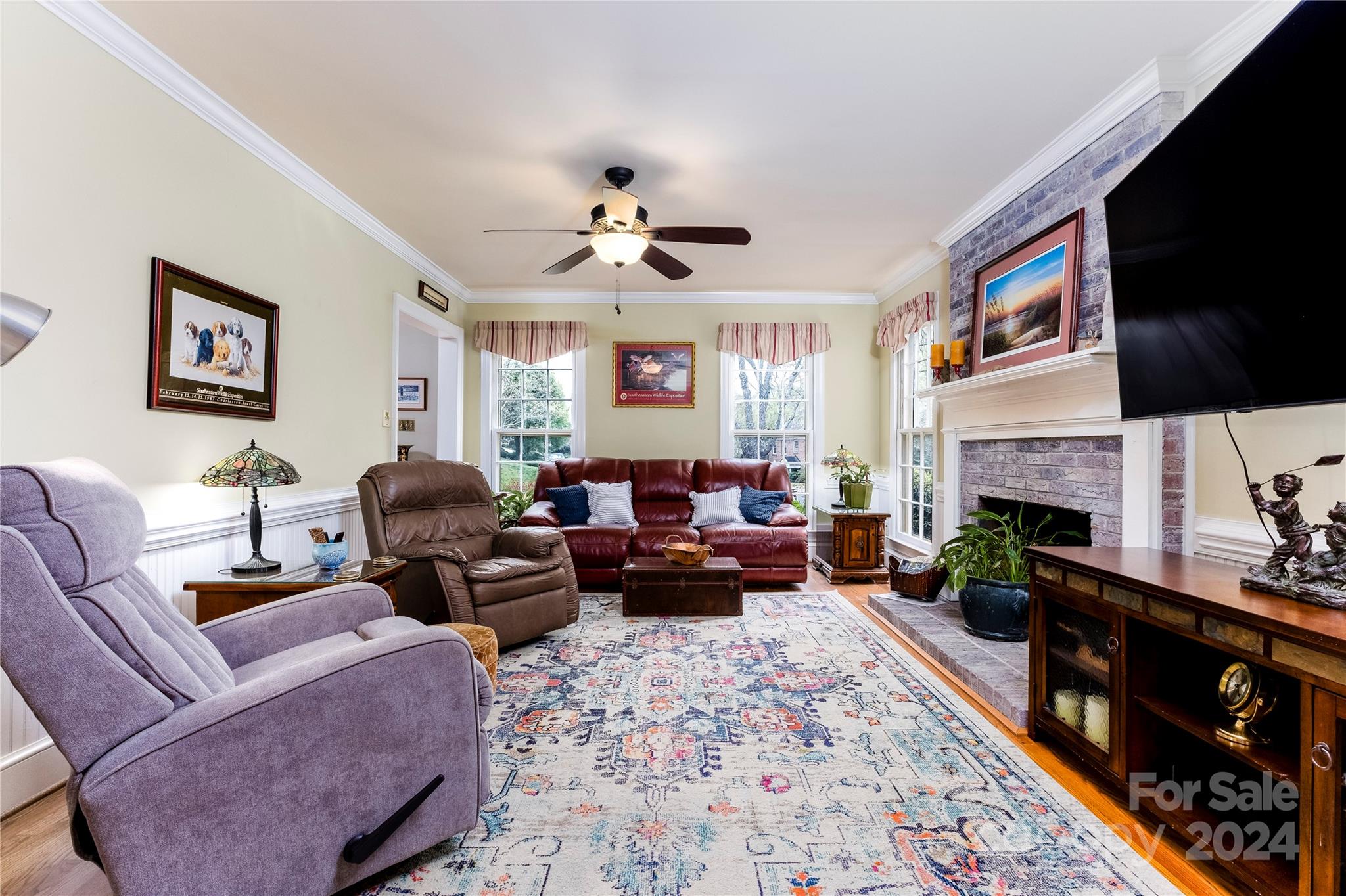 10744 Fairway Ridge Road Charlotte, NC 28277 - Photo 4 of 18 a living room with furniture a fireplace and a flat screen tv