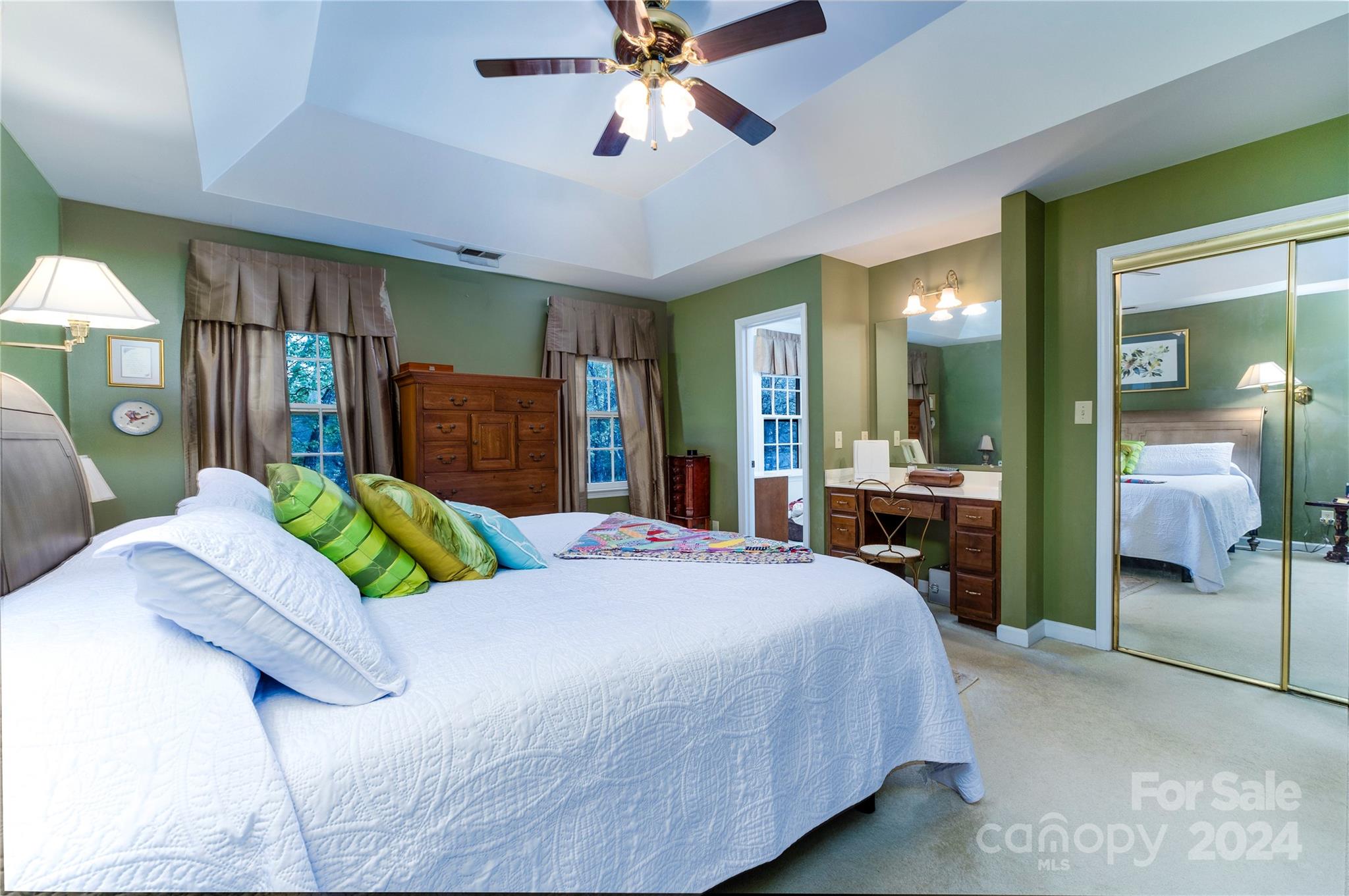 10744 Fairway Ridge Road Charlotte, NC 28277 - Photo 10 of 18 a bedroom with a bed mirror and a chandelier