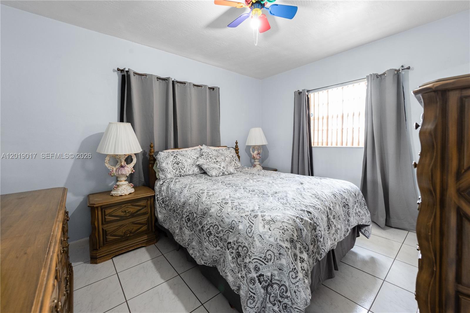 731 Northwest 17th Street Homestead, FL 33030 - Photo 11 of 29 a bedroom with a bed and a chandelier