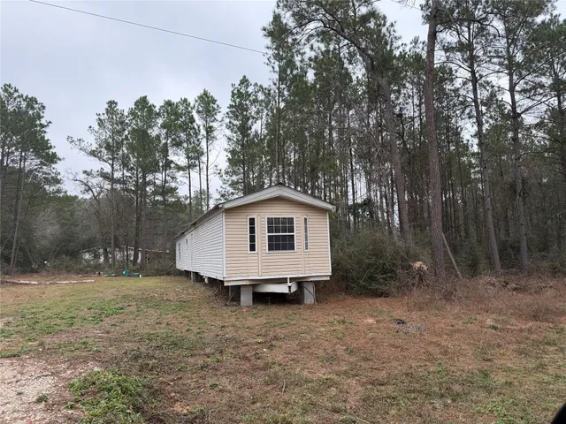 a white house that has a tree in front of it