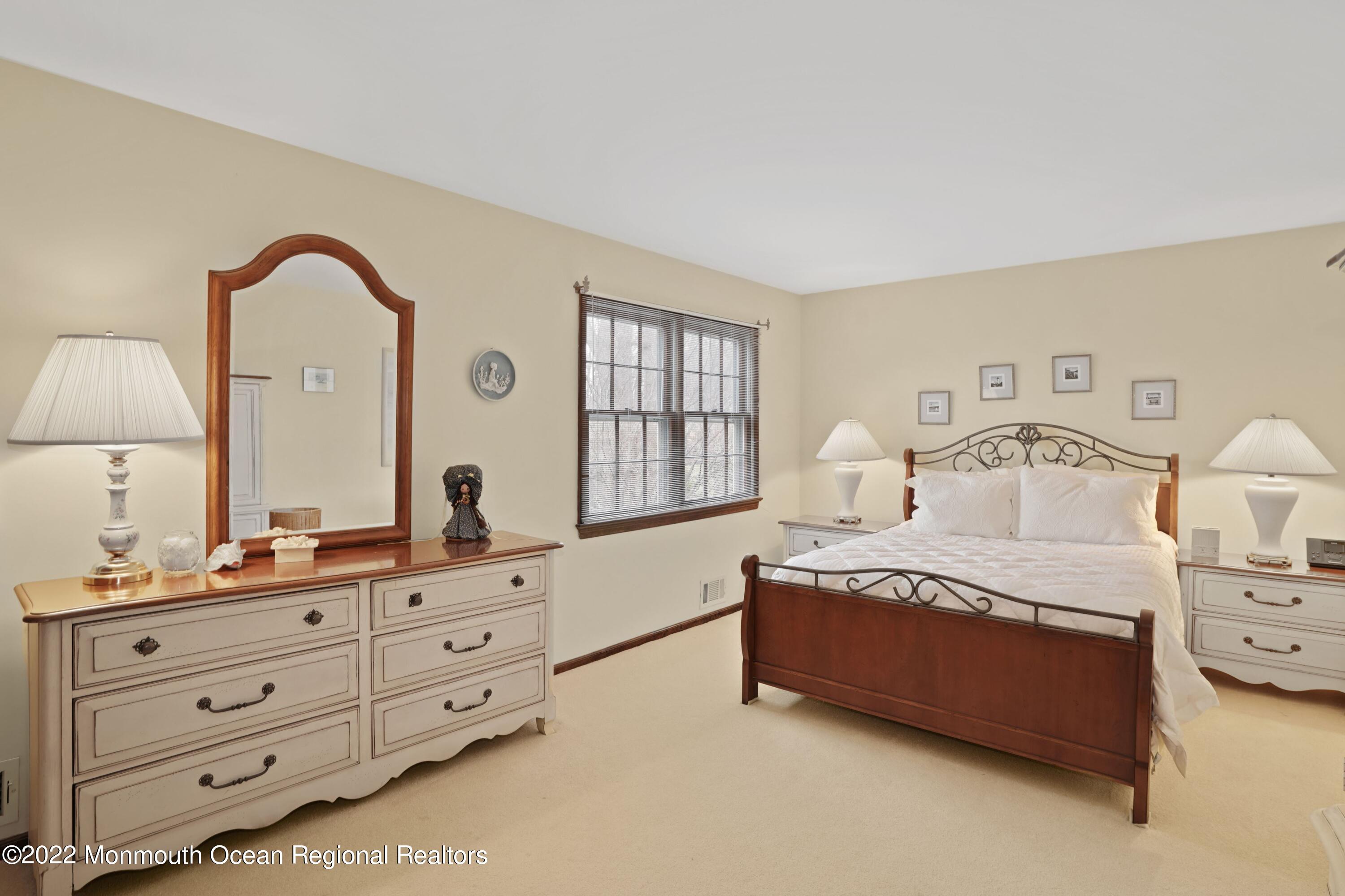 161 Hillyer Circle Middletown, NJ 07748 - Photo 36 of 64 a spacious bedroom with a bed a dresser and window