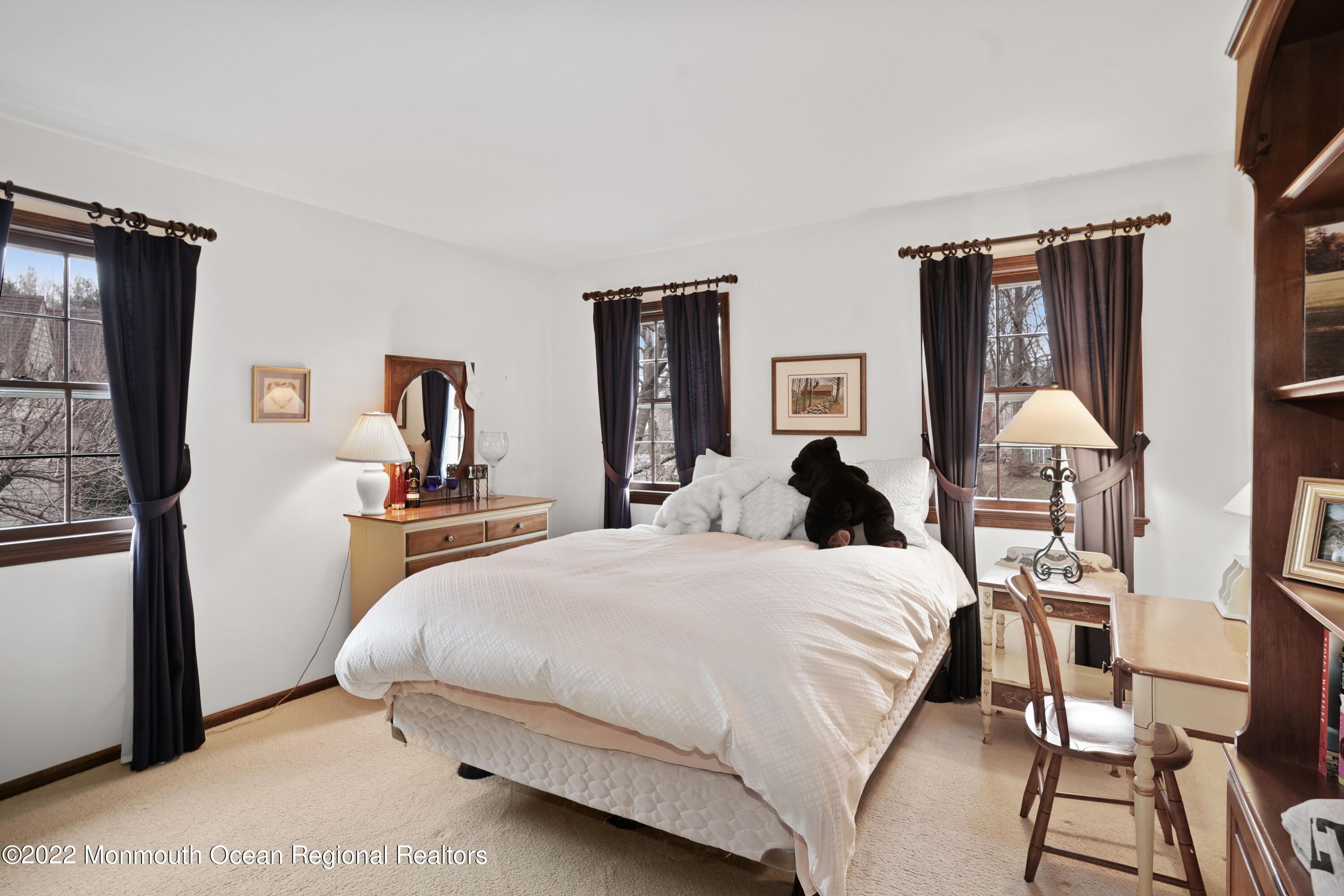 161 Hillyer Circle Middletown, NJ 07748 - Photo 39 of 64 a bedroom with a bed a mirror and desk