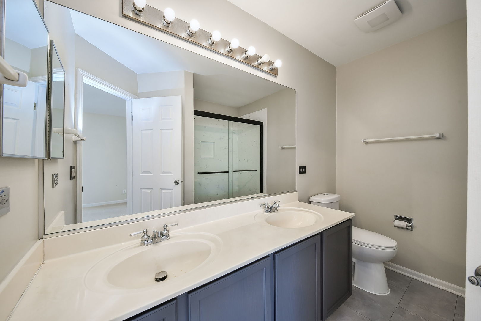 3447 Ravinia Circle Aurora, IL 60504 - Photo 14 of 14 a bathroom with a double vanity sink mirror and toilet
