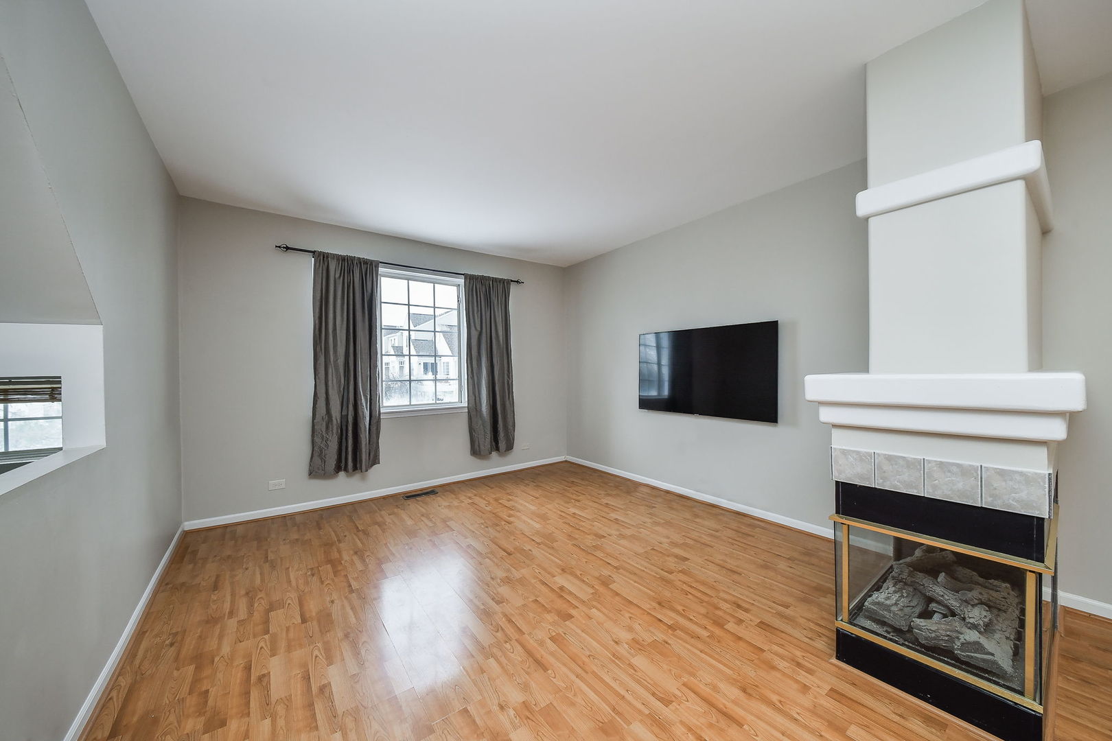 3447 Ravinia Circle Aurora, IL 60504 - Photo 2 of 14 a view of a livingroom with a fireplace and window