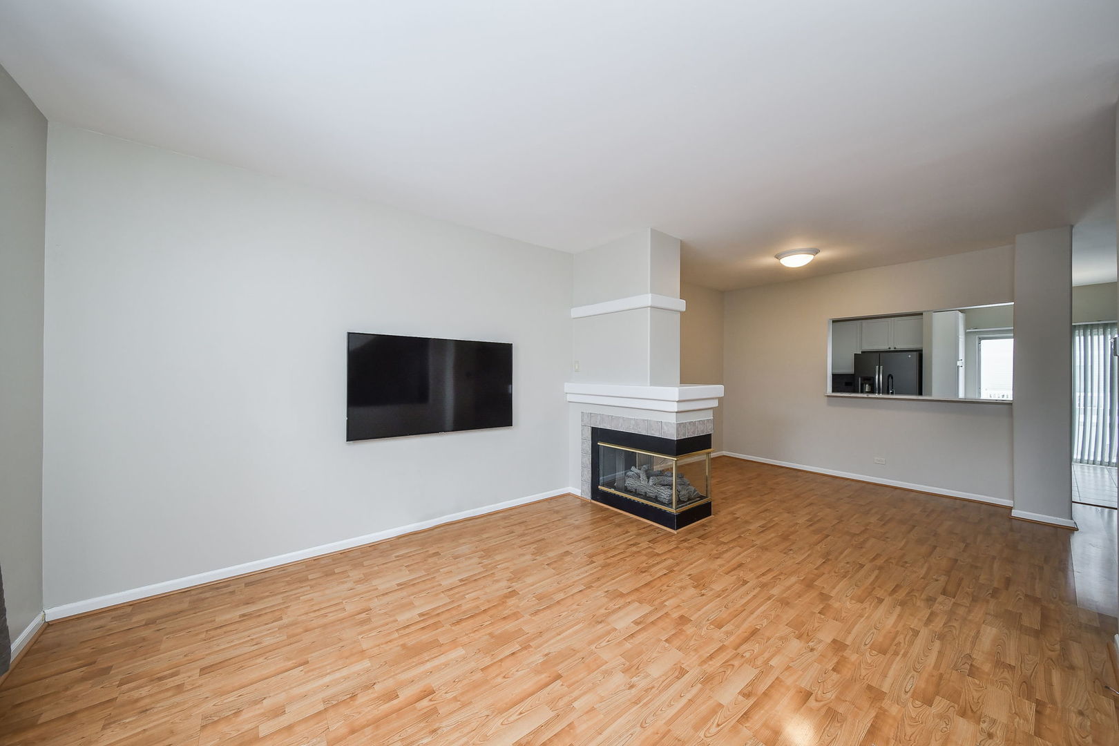 3447 Ravinia Circle Aurora, IL 60504 - Photo 3 of 14 a living room with a flat screen tv and a fireplace