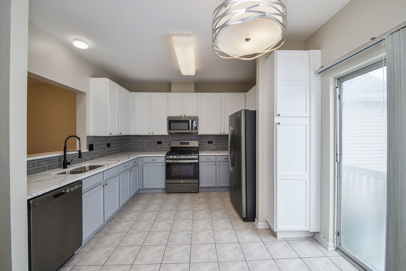 3447 Ravinia Circle Aurora, IL 60504 - Photo 5 of 14 a kitchen with stainless steel appliances granite countertop a refrigerator a sink dishwasher a stove with wooden cabinets and floor