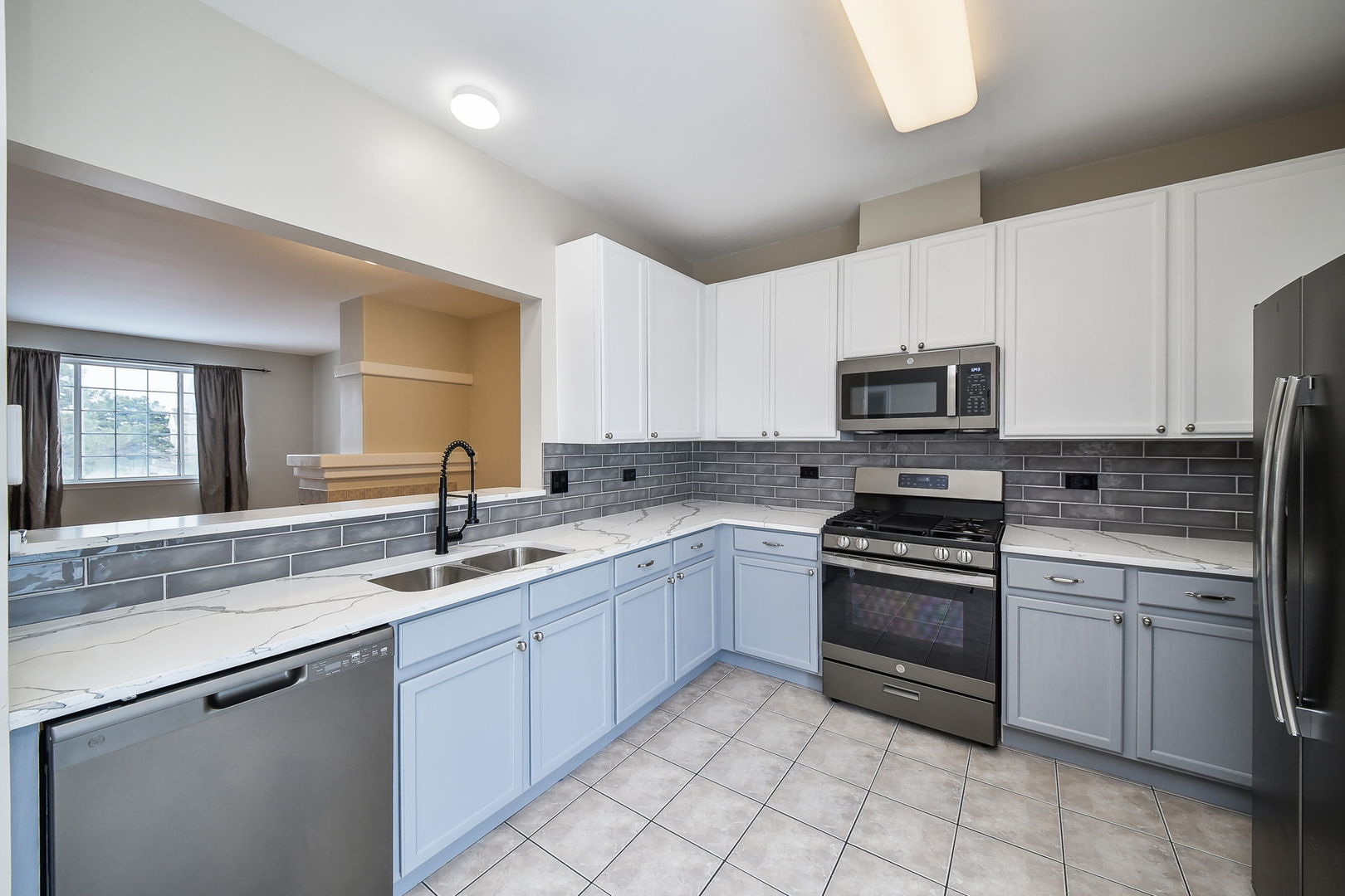 3447 Ravinia Circle Aurora, IL 60504 - Photo 6 of 14 a kitchen with a sink stove top oven and microwave