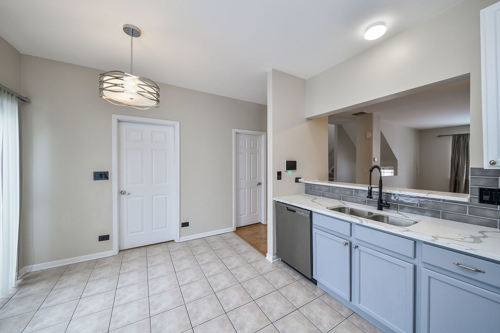 3447 Ravinia Circle Aurora, IL 60504 - Photo 7 of 14 a view of a kitchen with a sink and refrigerator