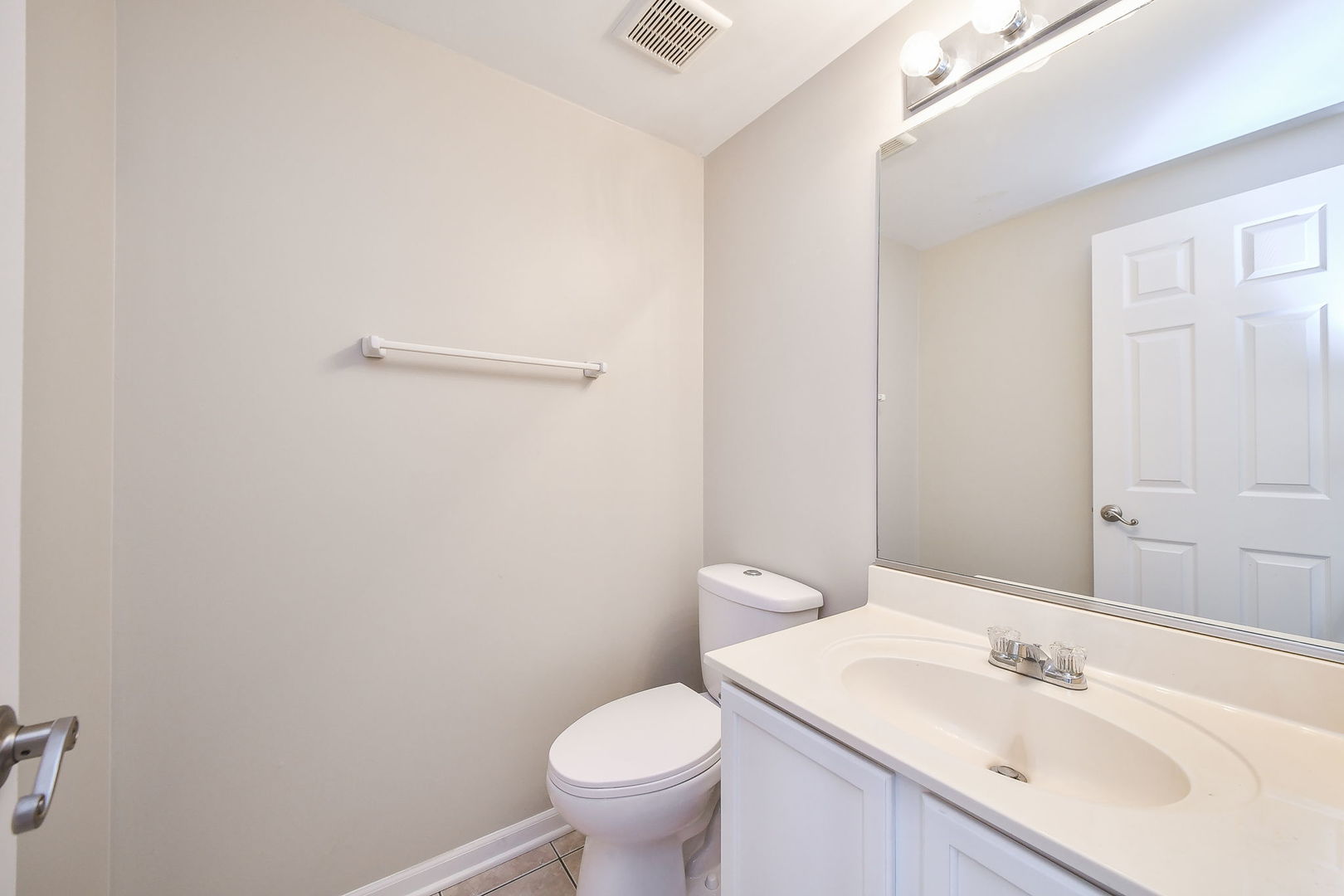 3447 Ravinia Circle Aurora, IL 60504 - Photo 9 of 14 a bathroom with a sink a toilet and a mirror