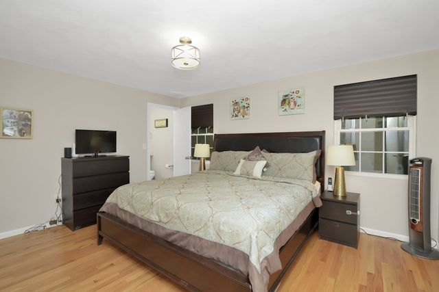 a bedroom with a bed and a television