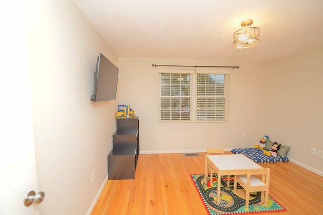 a bedroom with a bed and a tv