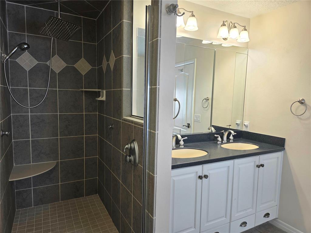 34041 Highland Road Leesburg, FL 34788 - Photo 18 of 33 a bathroom with a sink vanity granite and a mirror