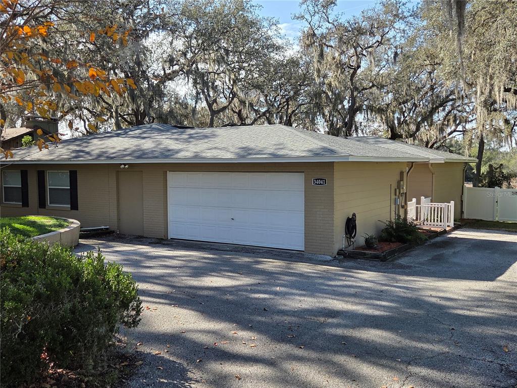 34041 Highland Road Leesburg, FL 34788 - Photo 24 of 33 a view of a house with a garage