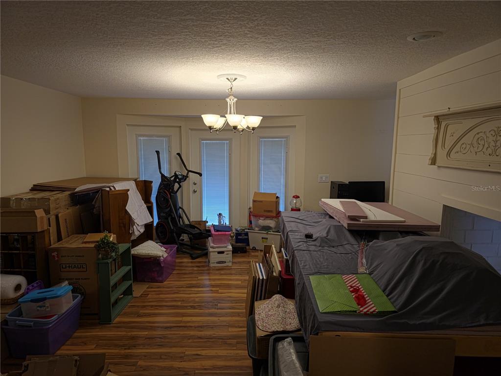 34041 Highland Road Leesburg, FL 34788 - Photo 27 of 33 a living room with furniture and wooden floor