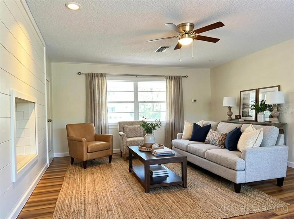 34041 Highland Road Leesburg, FL 34788 - Photo 3 of 33 a living room with furniture and a large window