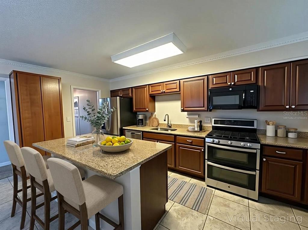 34041 Highland Road Leesburg, FL 34788 - Photo 6 of 33 a kitchen with granite countertop stainless steel appliances and wooden cabinets