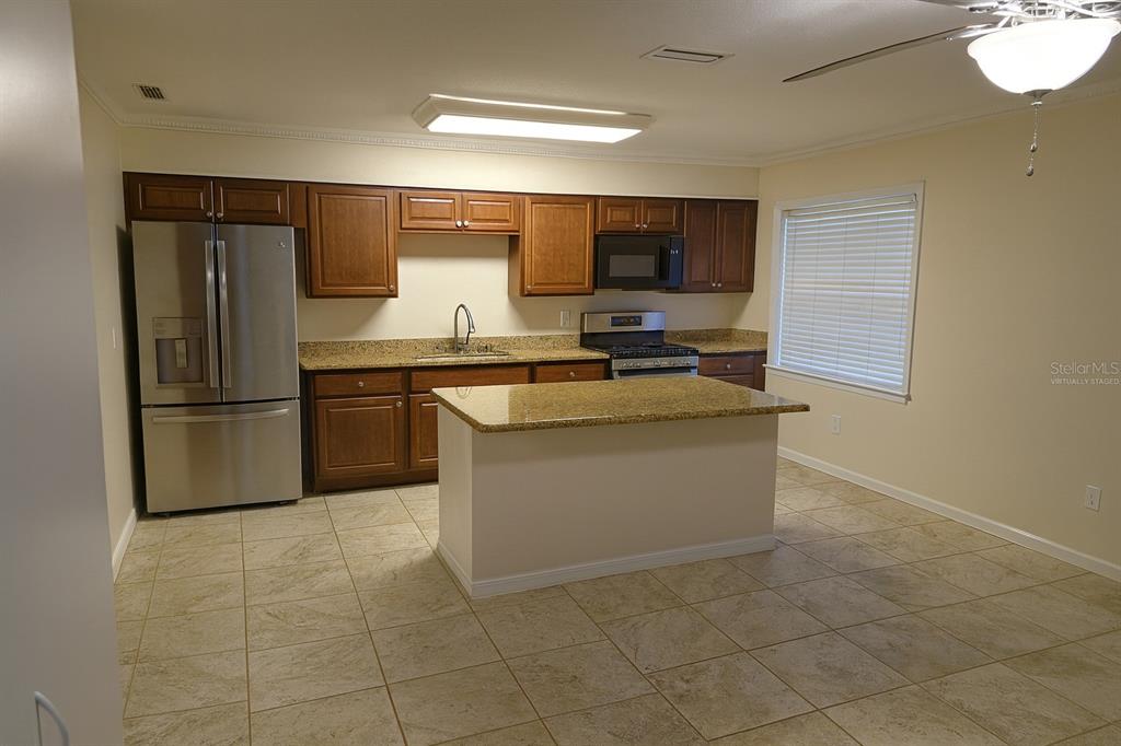 34041 Highland Road Leesburg, FL 34788 - Photo 7 of 33 a kitchen with a sink appliances and cabinets