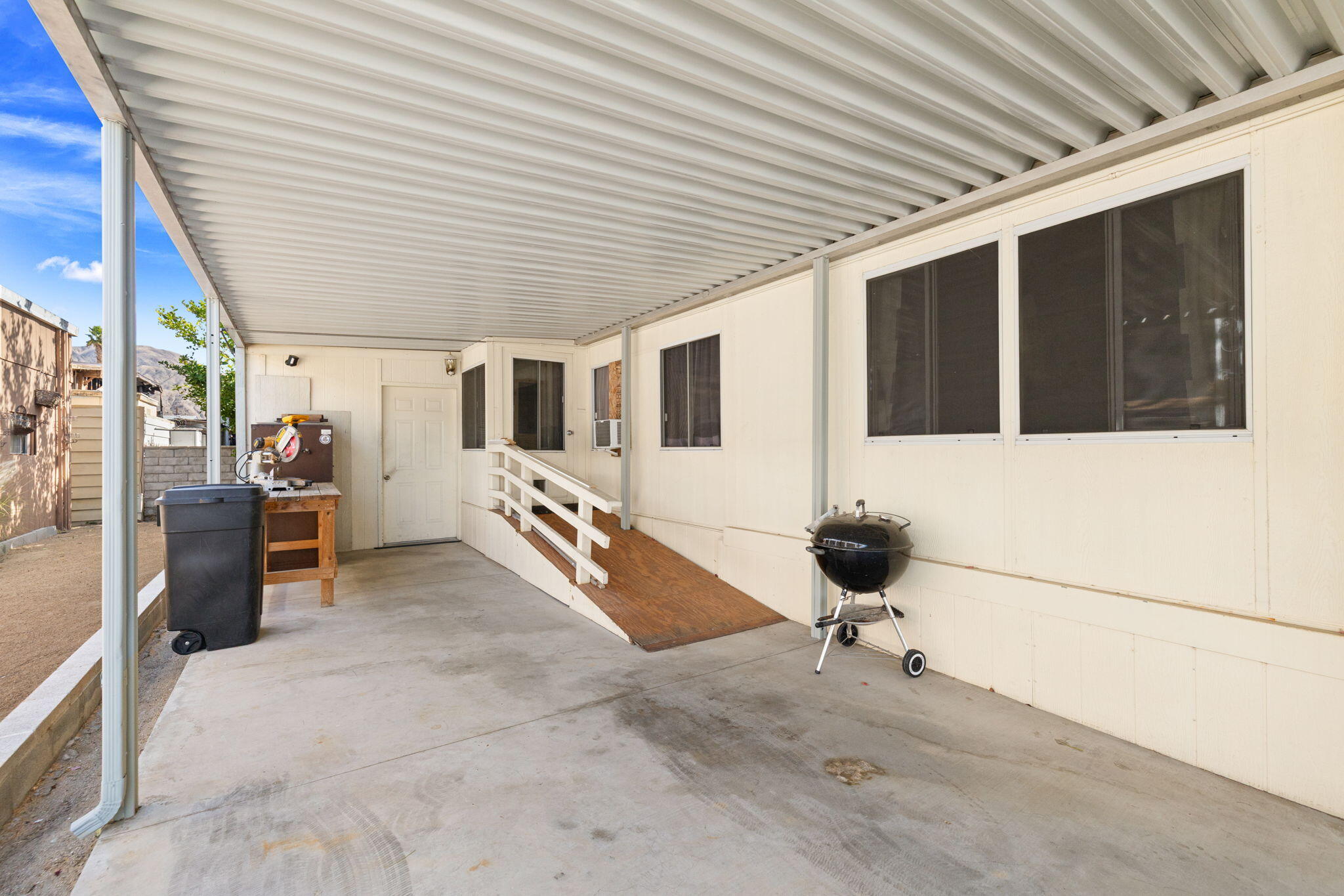 74711 Dillon Road, Unit 318 Desert Hot Springs, CA 92241 - Photo 5 of 53 a view of a porch with wooden fence