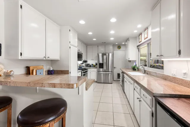 a bedroom with a bed a bookshelf and a book shelf