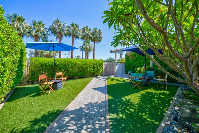 a living room with furniture fireplace and a large window