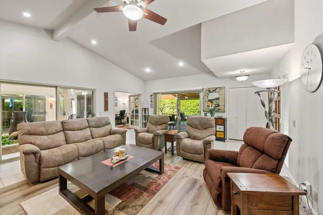 a dining room with furniture a chandelier and a rug