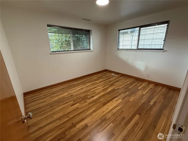 a view of room with window and hardwood floor
