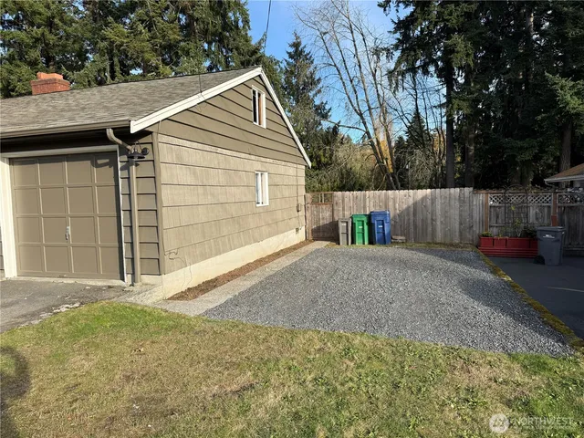 a view of empty room with wooden floor and fireplace