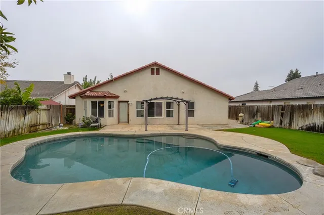a white house covered with tall trees