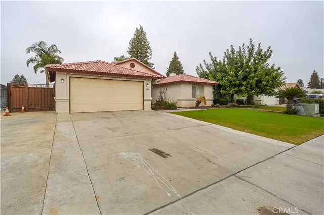 a view of a house with a yard and potted plants