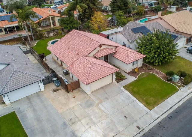an aerial view of a house with garden space and street view