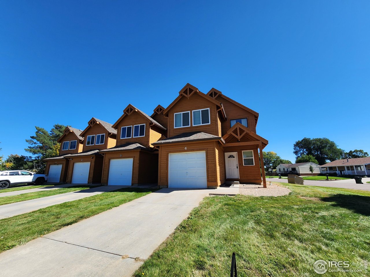 851 Denver Street, Unit 4 Sterling, CO 80751 - Photo 1 of 39 a front view of a house with a garden
