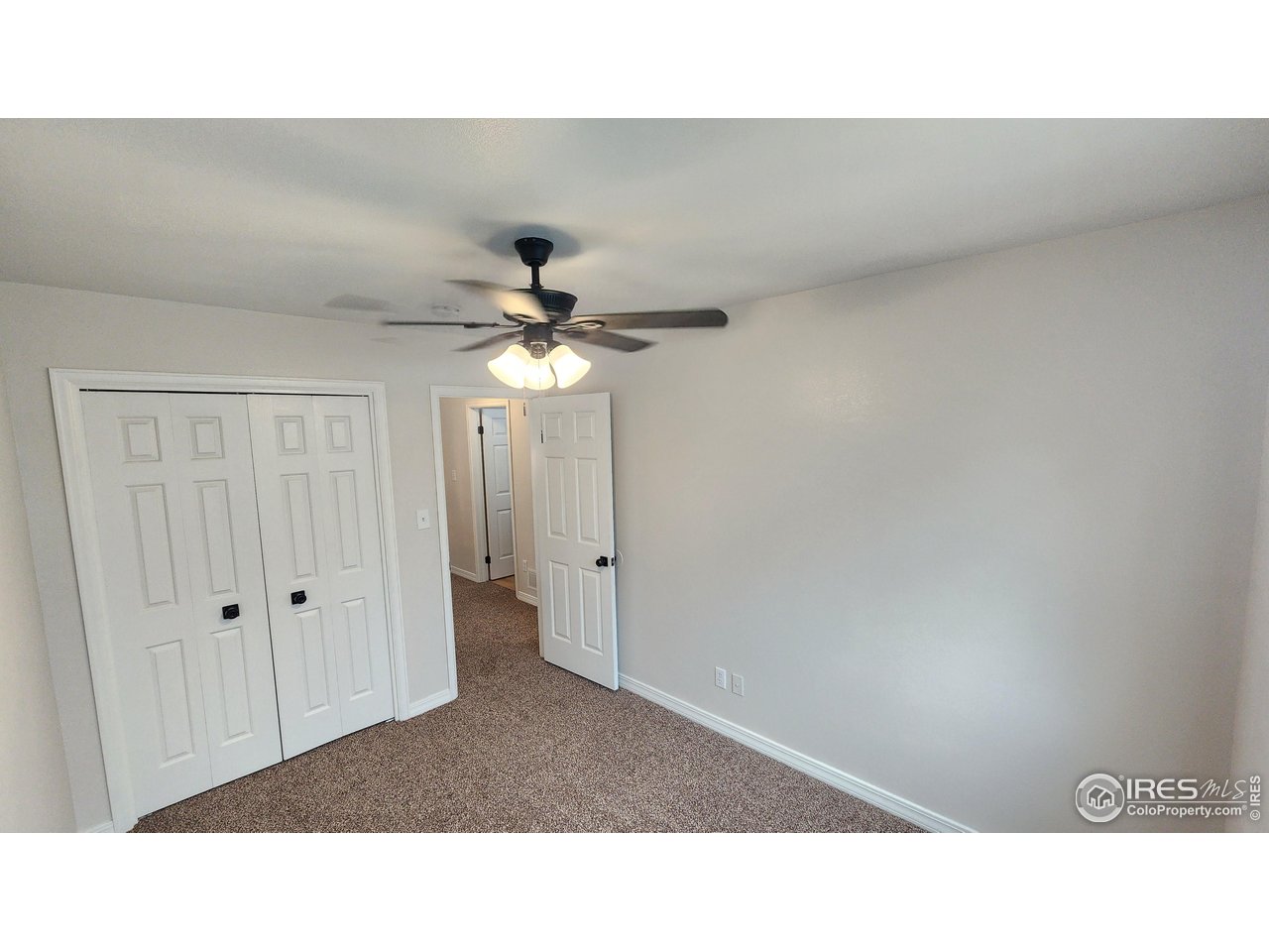 851 Denver Street, Unit 4 Sterling, CO 80751 - Photo 27 of 39 a open hall with a ceiling fan