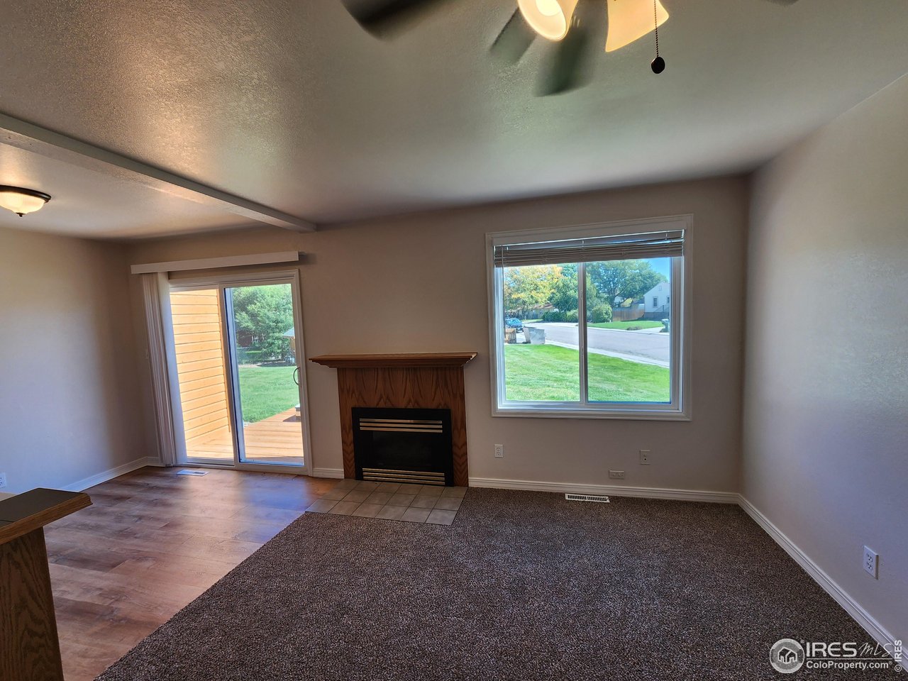 851 Denver Street, Unit 4 Sterling, CO 80751 - Photo 4 of 39 an empty room with windows and fireplace