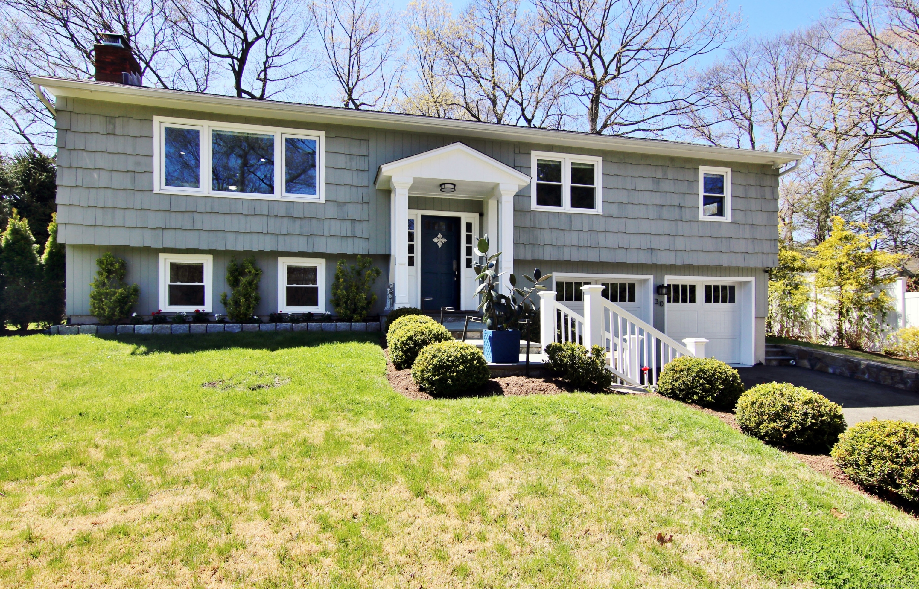 a front view of a house with a yard and garage