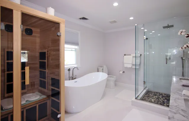 a bathroom with a double vanity sink toilet and shower