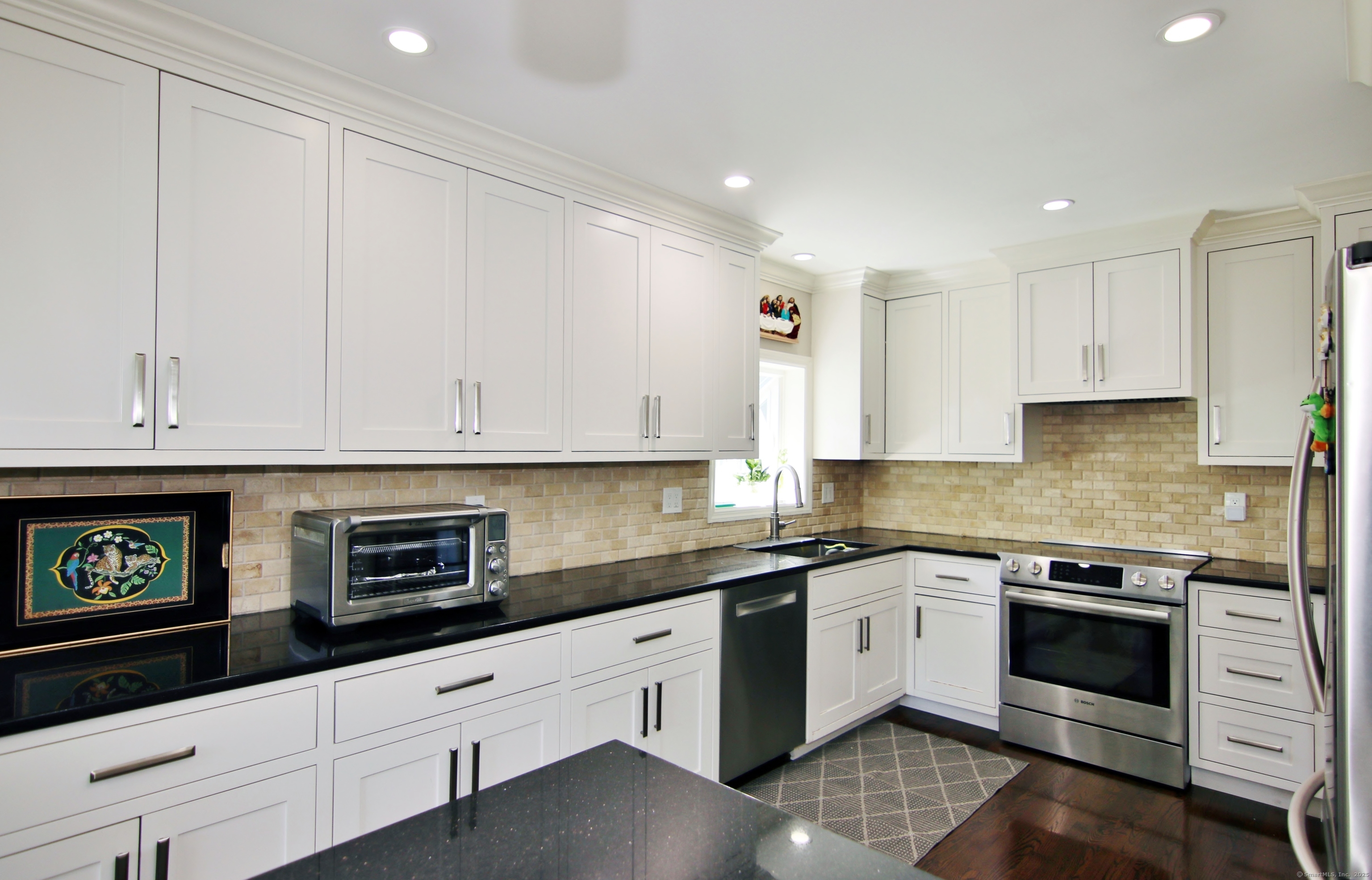 30 Possum Circle Norwalk, CT 06854 - Photo 6 of 23 a kitchen with granite countertop white cabinets and white appliances