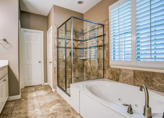 a bathroom with a bathtub and a shower