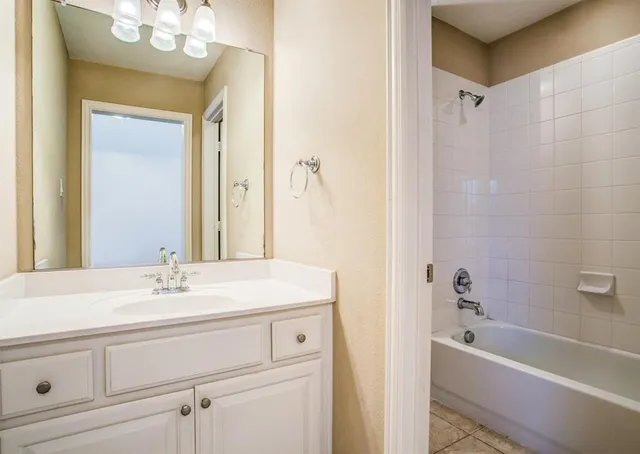 a bathroom with a sink a mirror and a bathtub