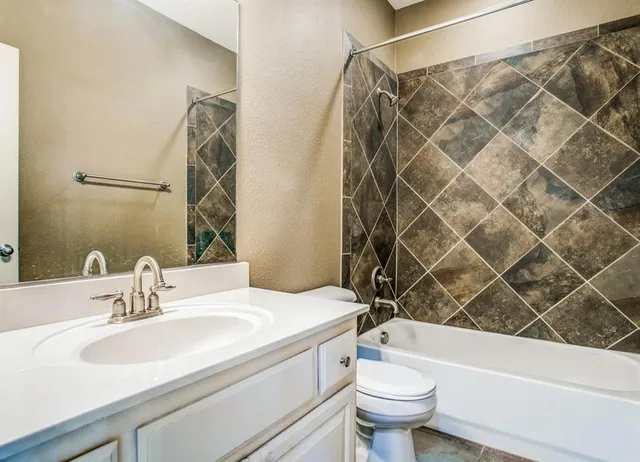 a bathroom with a sink a toilet and a shower