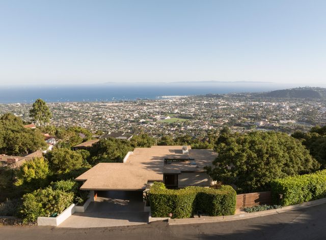 an aerial view of a house with a yard and garden
